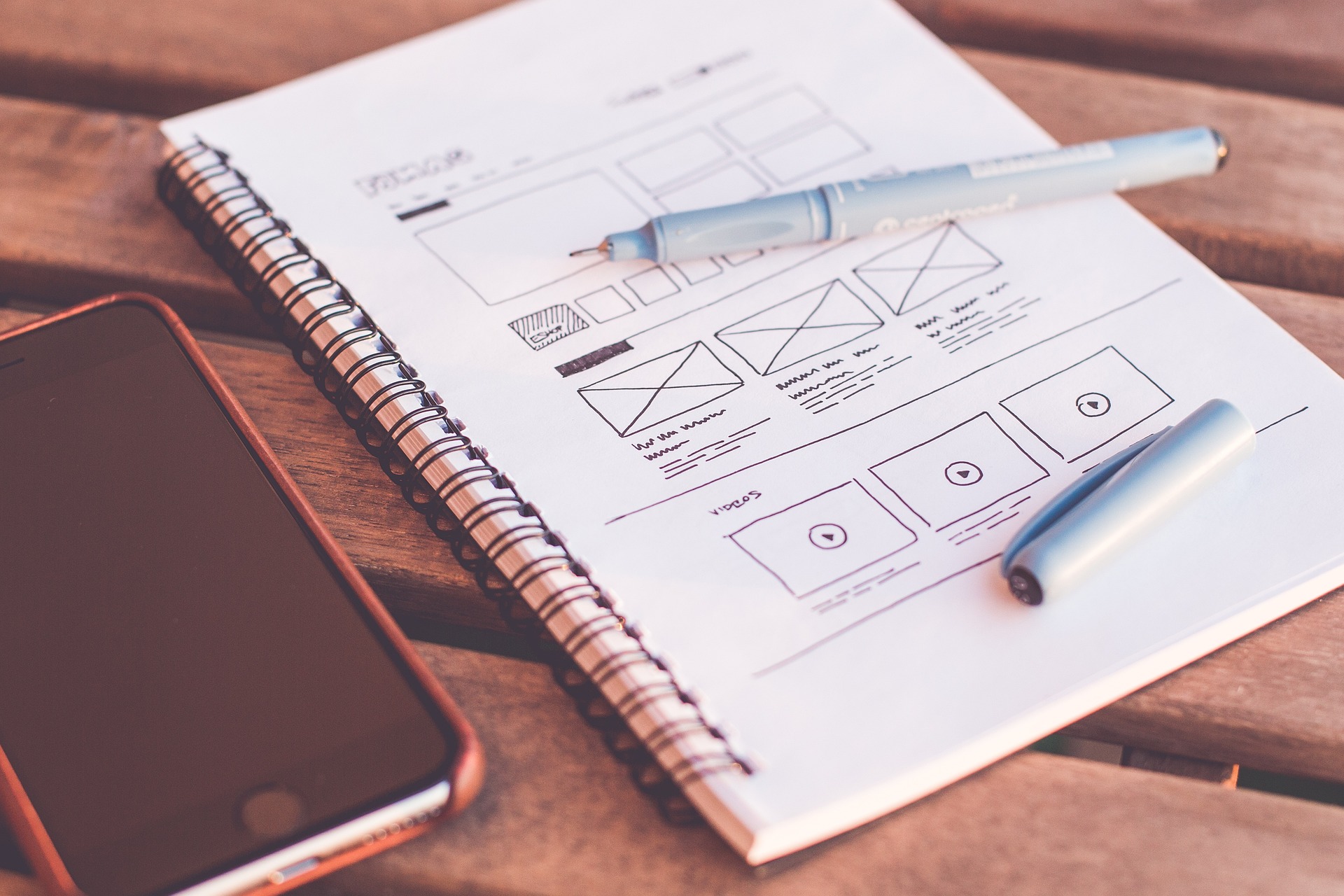 a wireframe of a website design on a notepad